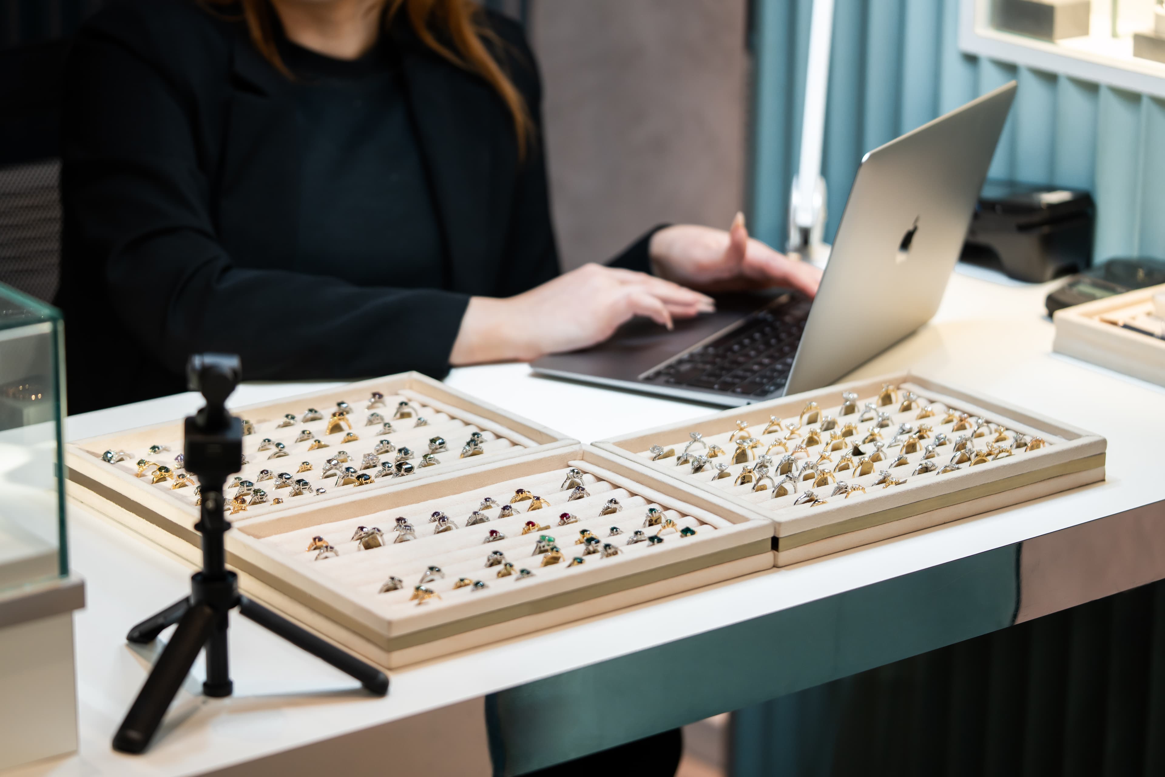 A consultation at the Aardvark Jewellery studio, ring trays laid out beside the laptop