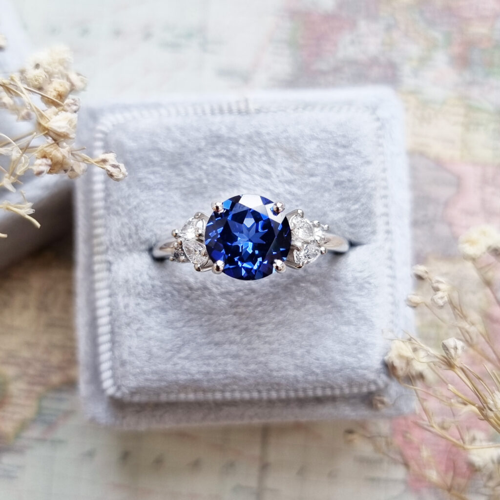 Lab grown blue sapphire and diamond cluster engagement ring